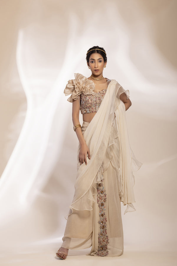 Gold Shimmer Georgette Saree With Embellished Border And Sheer Ruffle, One–Strap Blouse With Puff Sleeve.