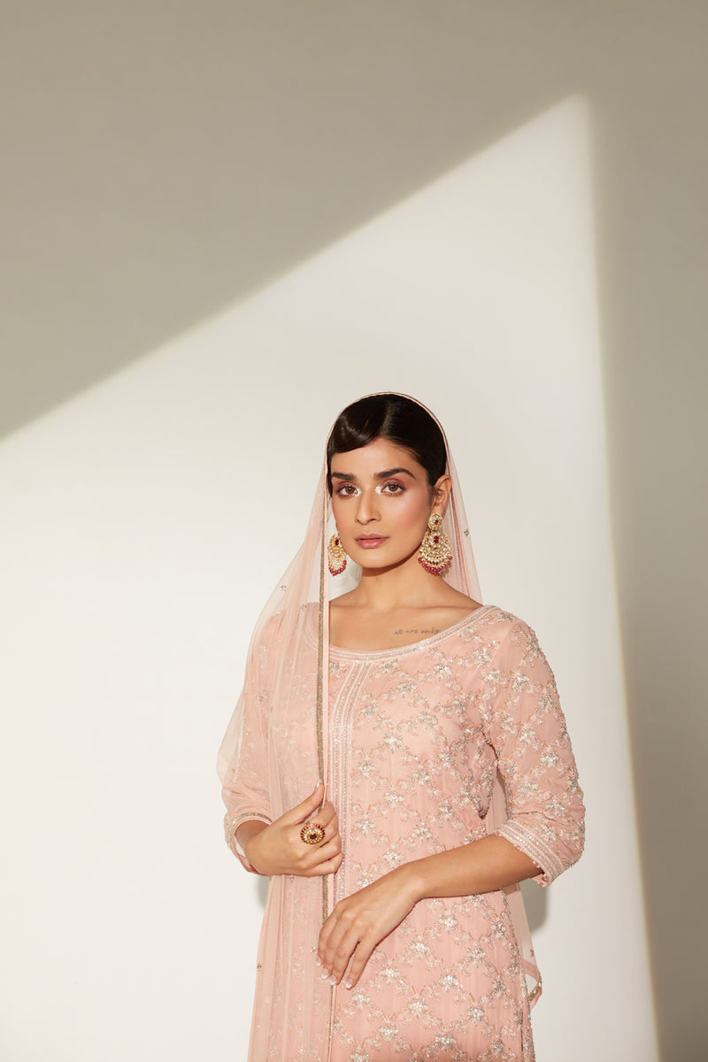 Round neck embellished tunic paired with gathered sharara and four side dupatta