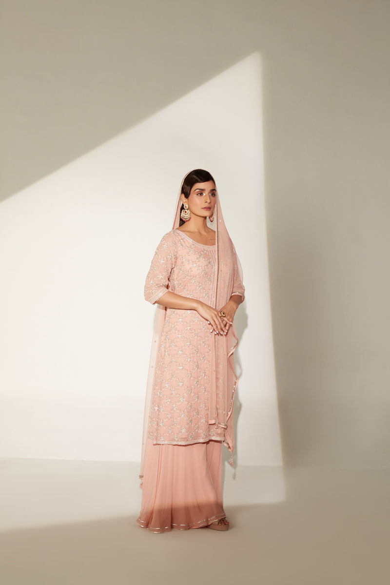 Round neck embellished tunic paired with gathered sharara and four side dupatta