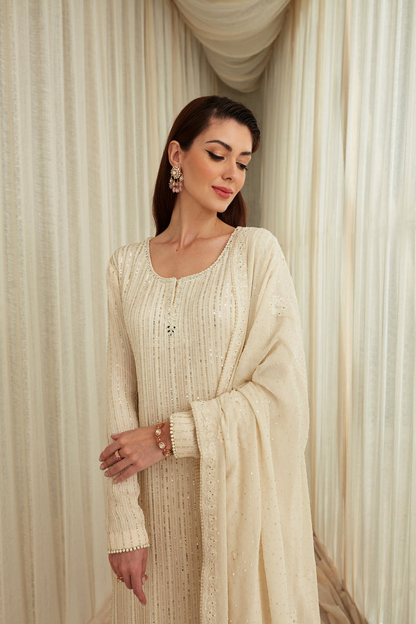Ivory Dori Work And Sequins Suit Paired With Ivory Chevron Sequins Garara And Georgette Light Chikankari Dupatta.