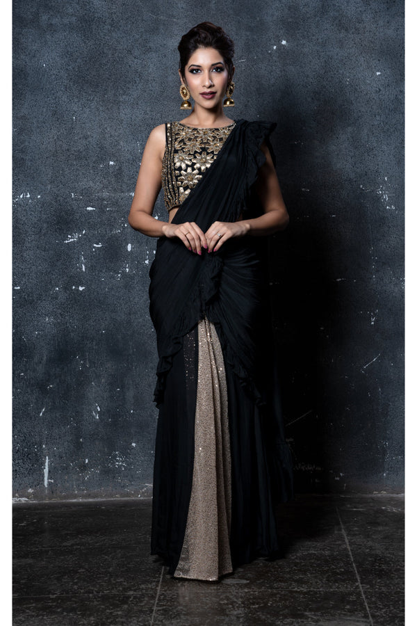 Black stitched ruffles saree with gold shimmer pleats & feathers with black & gold leather applique embroidered blouse