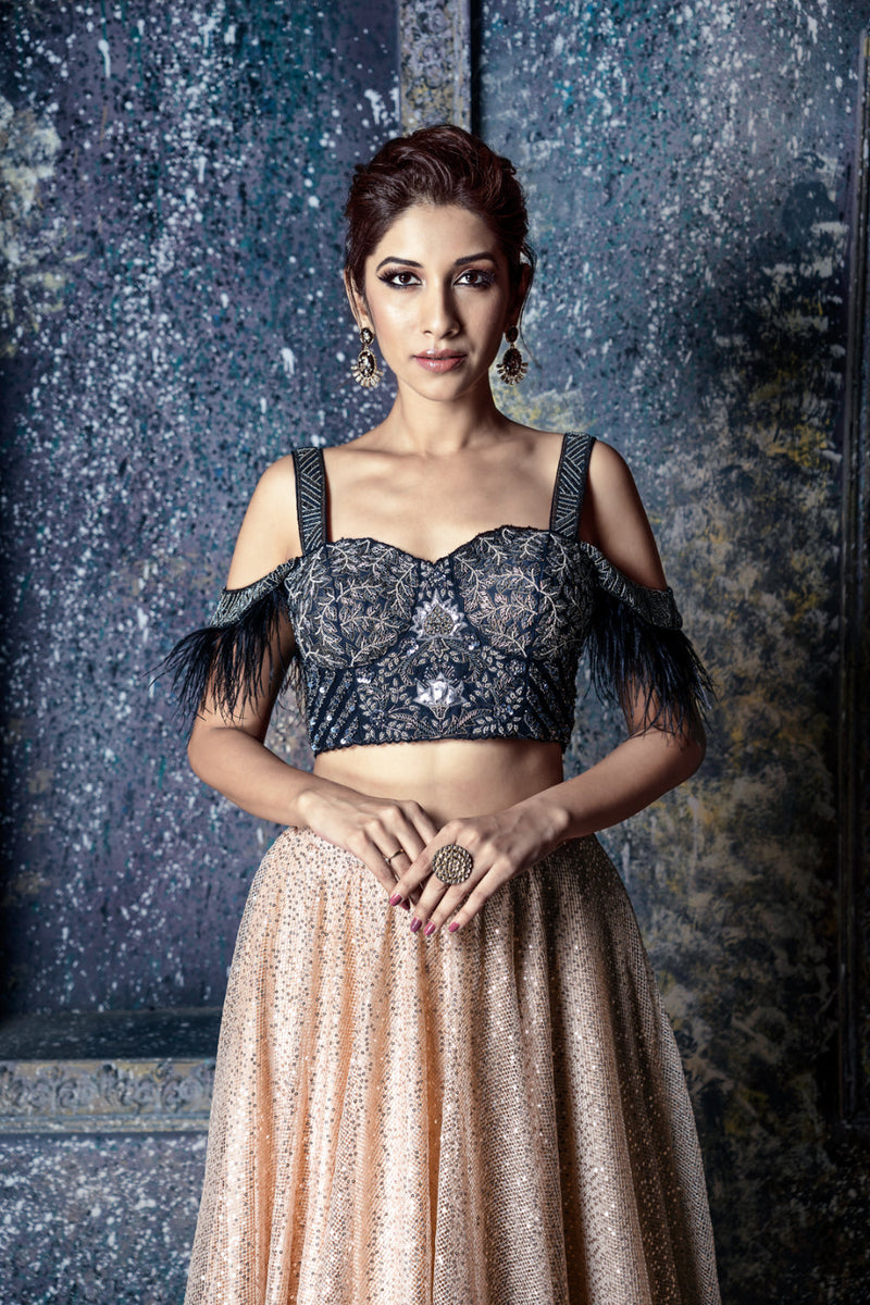 Black & dull silver embroidered cold shoulder blouse with feather detail & gold sequin skirt with feathers & ruffled dupatta