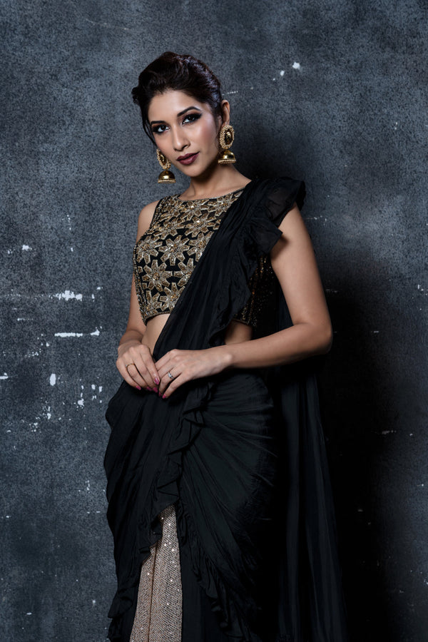 Black stitched ruffles saree with gold shimmer pleats & feathers with black & gold leather applique embroidered blouse