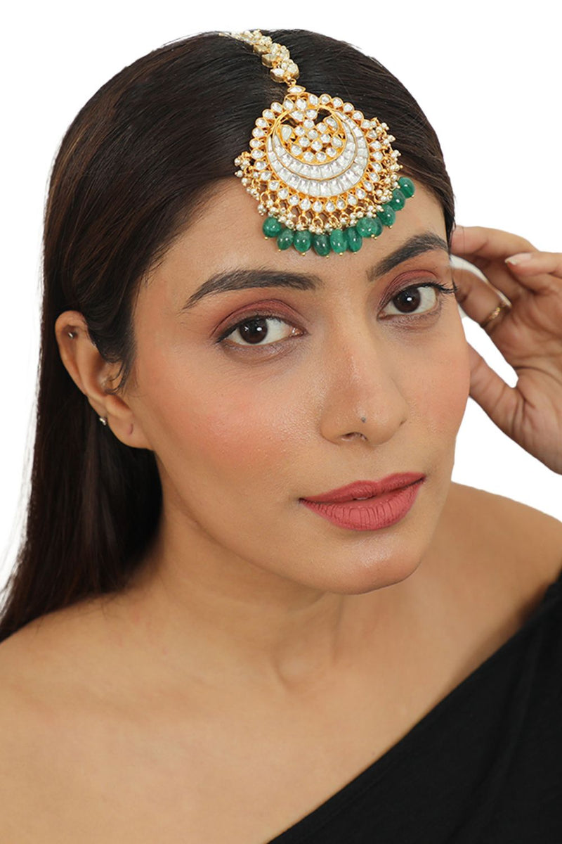 HEAVY  MAANGTIKKA STUDDED WITH JADTAR STONES AND GREEN DROPS