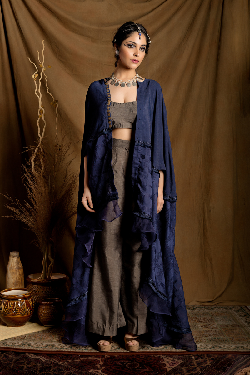 Navy blue high-low cape layered over bustier and pants