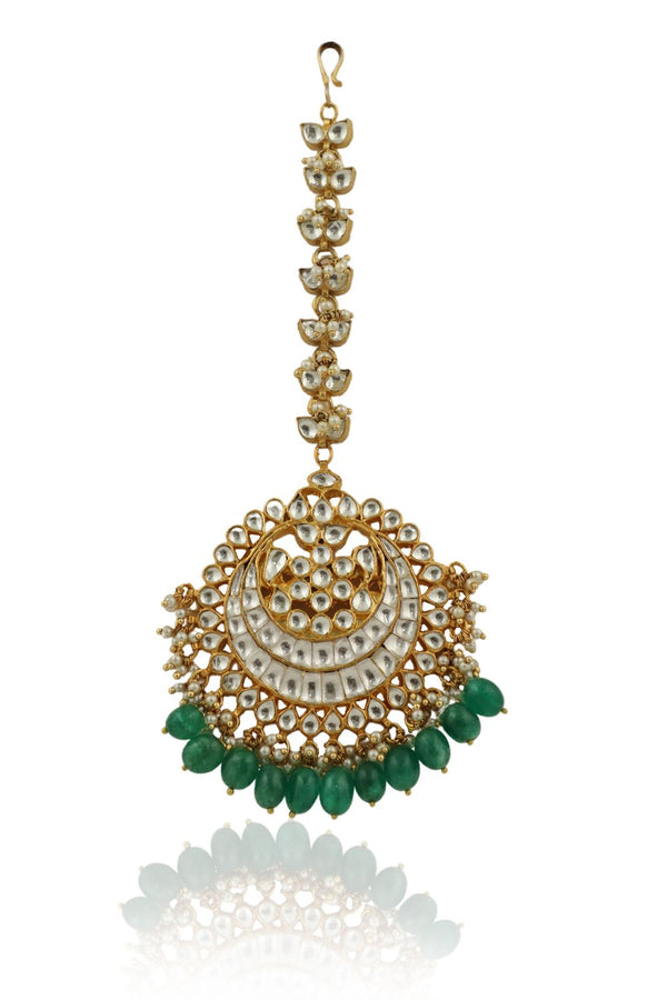 HEAVY  MAANGTIKKA STUDDED WITH JADTAR STONES AND GREEN DROPS