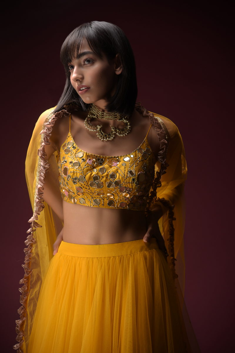 Tuscan Sun Yellow Skirt And Crop Top Set With Heavy Hand Embroidery Work Using Flower And Leaf Shaped Mirrors