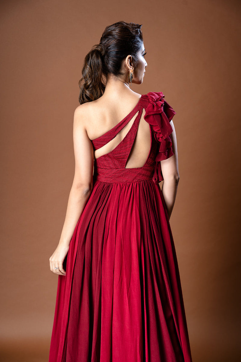 Red pure crepe one shoulder gown with ruffled sleeve & self thread embroidery