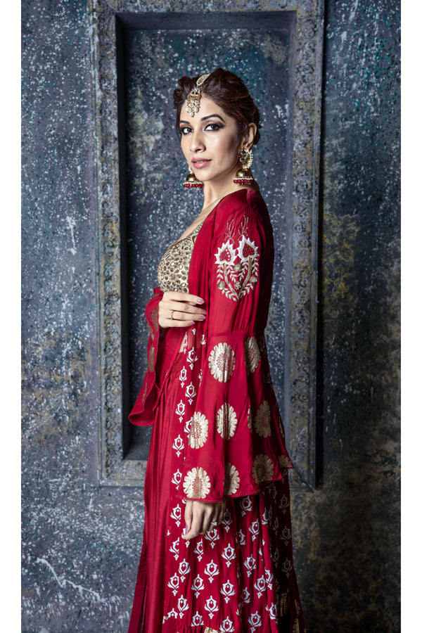 Gold leather applique embroidered blouse with red draped slit skirt & foil printed organza cape with sleeve embroidery