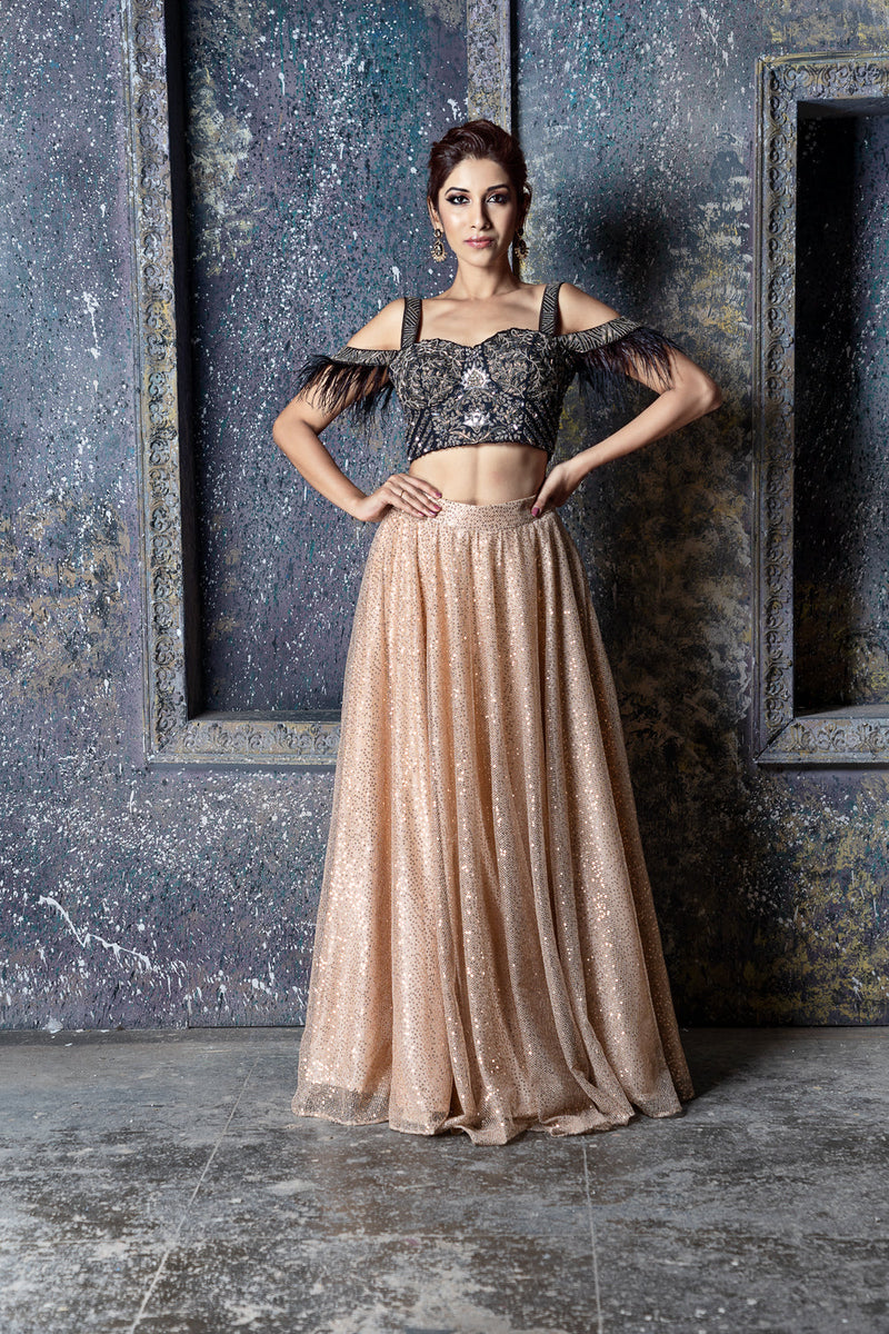 Black & dull silver embroidered cold shoulder blouse with feather detail & gold sequin skirt with feathers & ruffled dupatta