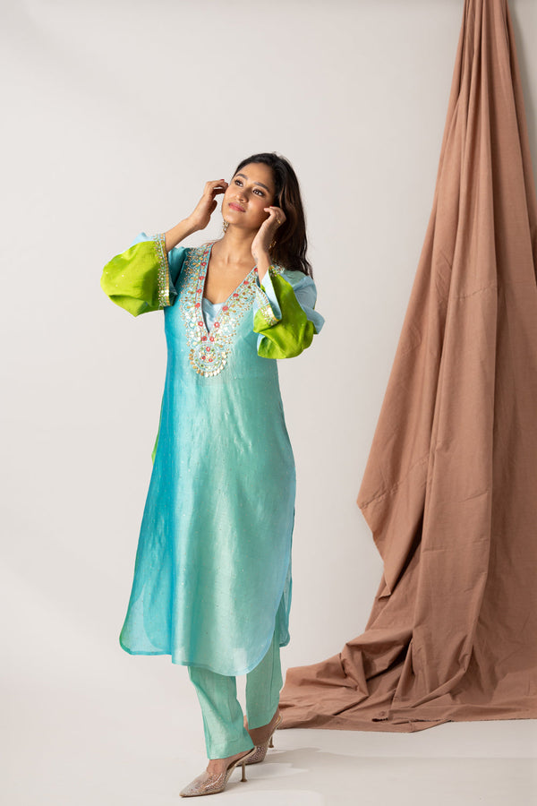 Falling Raw Silk Mukaish Fabric With Hand Embroidered Neck And Sleeves, Includes A Pant