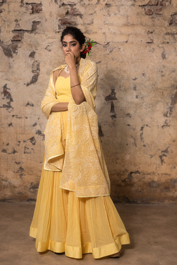Yellow Pleated Sharara Paied With Peplum Top And Embroidered Dupatta