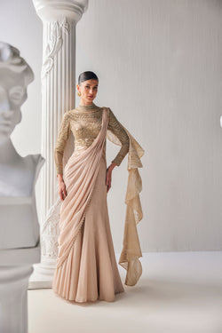 Golden Cream Draped Saree In Luxurious Shimmer Chiffon Offset With A Zardozi Blouse And An Elaborate High Neckline.