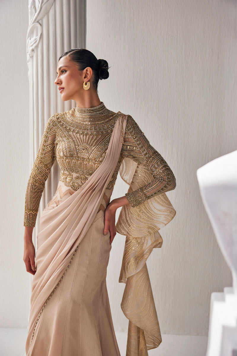 Golden Cream Draped Saree In Luxurious Shimmer Chiffon Offset With A Zardozi Blouse And An Elaborate High Neckline.