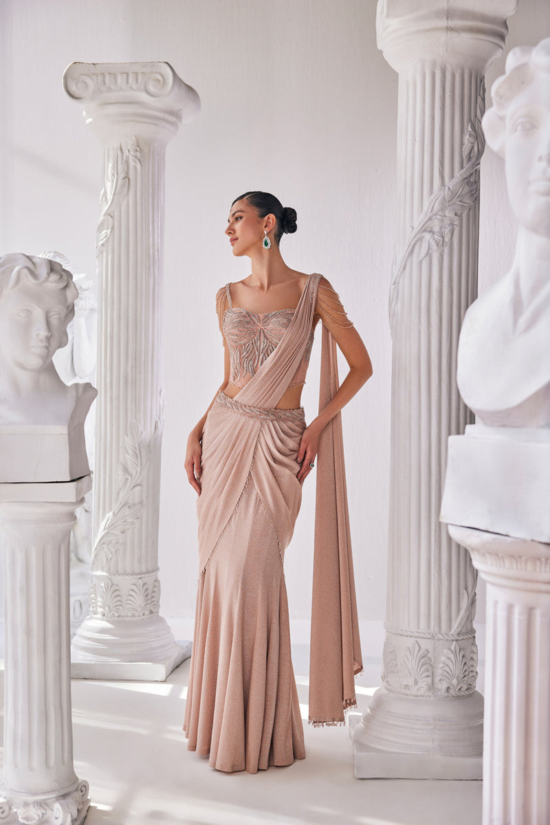 Peach Draped Saree In Luxurious Shimmer Lyrcra. It Is Paired With Anembroidered Corset Blouse And Highlighted With A Statement Belt.