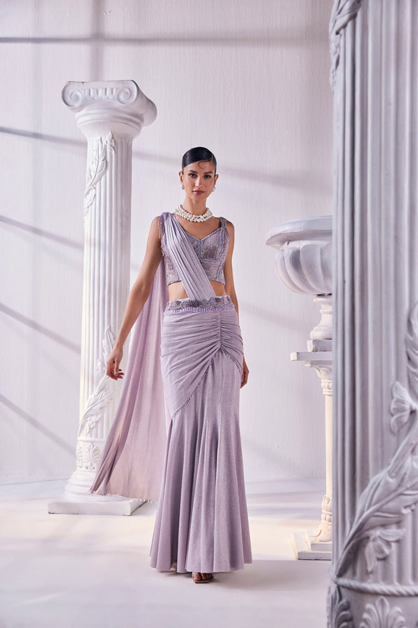 Draped Saree In Luxurious Shimmer Lycra Designed In Lilac Colour, An Emroidered Corset And A Belt.