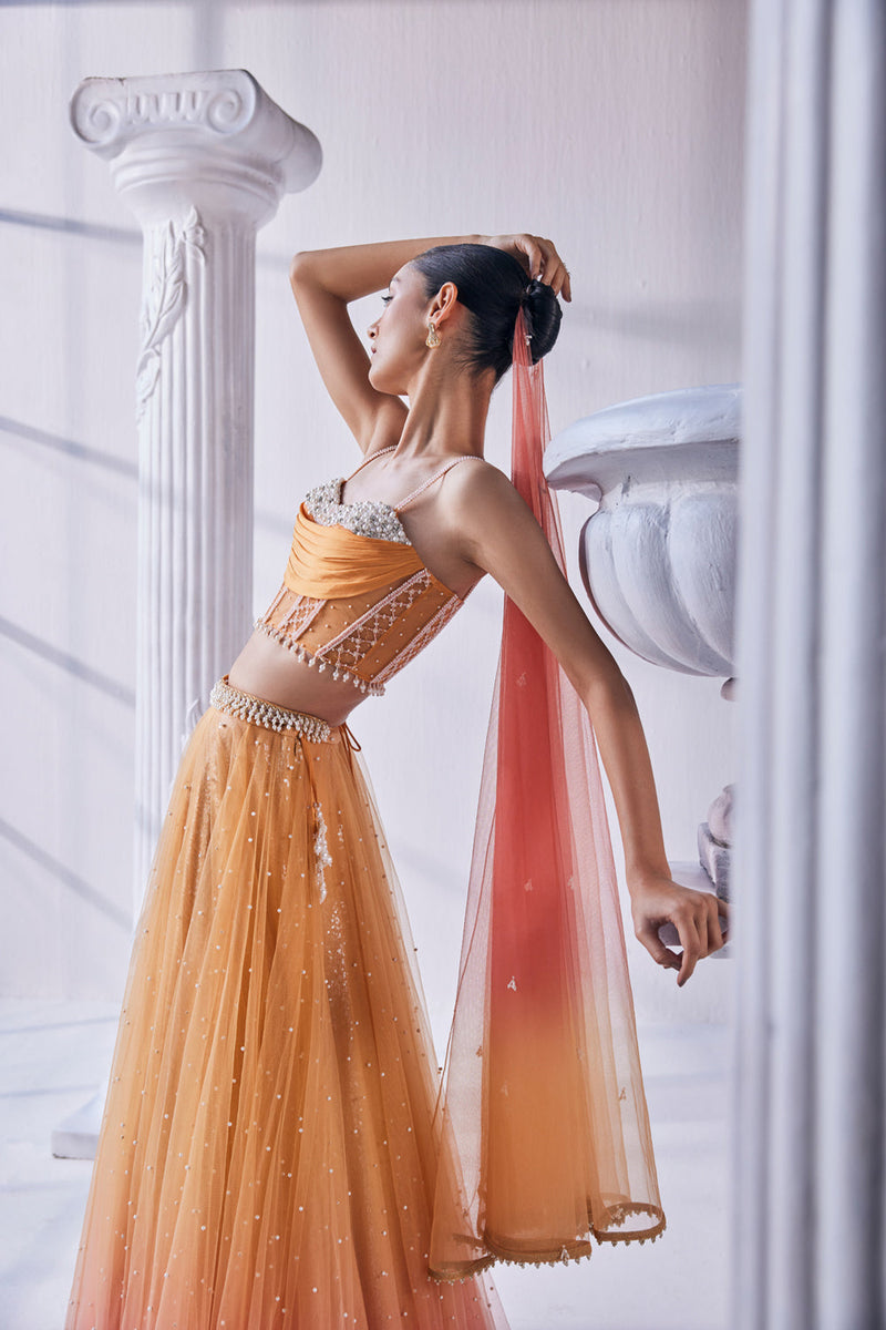 Satin Georgette Ombre Lehenga In Sequin And Pearl Detail. It Is Paired With A Bead Work Corset, Belt And A Dupatta.