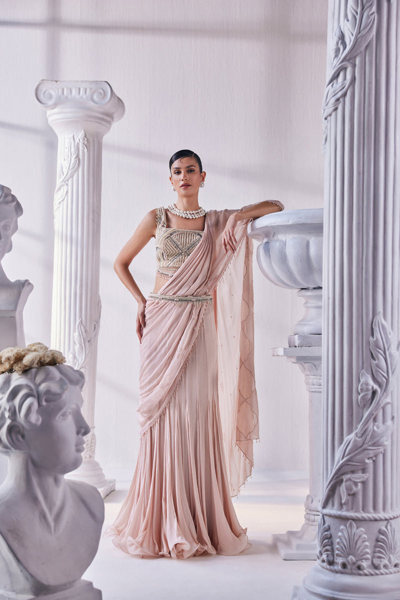 Peach Chiffon Drape Saree With Bead Work Detail Paired With A Heavy Emroidered Blouse And A Belt.