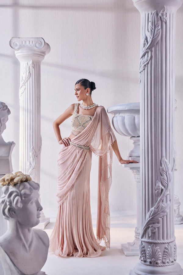 Peach Chiffon Drape Saree With Bead Work Detail Paired With A Heavy Emroidered Blouse And A Belt.