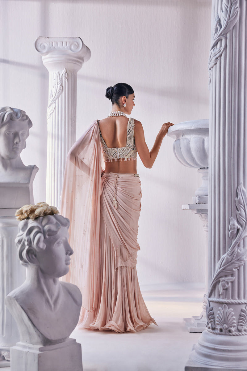 Peach Chiffon Drape Saree With Bead Work Detail Paired With A Heavy Emroidered Blouse And A Belt.