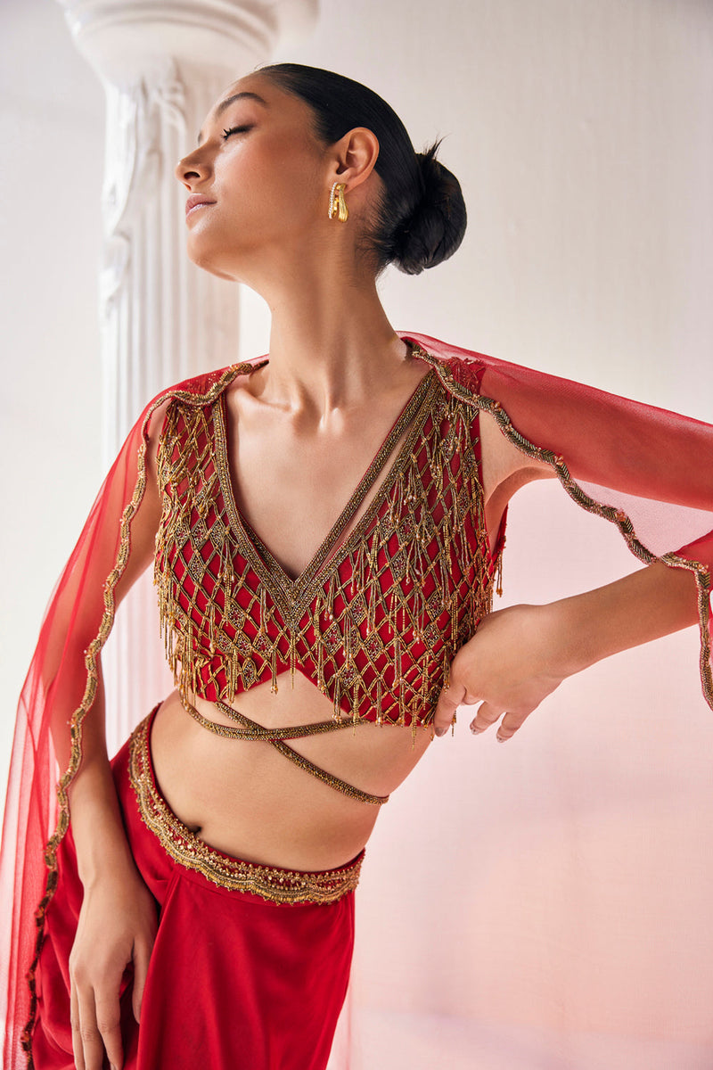 Elegant Red Ensemble Features A Royal Satin Skirt, Fully Embroidered Blouse, Belt And A Cape In A Soft Net.