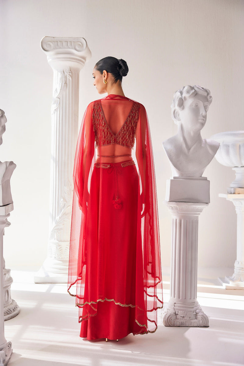 Elegant Red Ensemble Features A Royal Satin Skirt, Fully Embroidered Blouse, Belt And A Cape In A Soft Net.