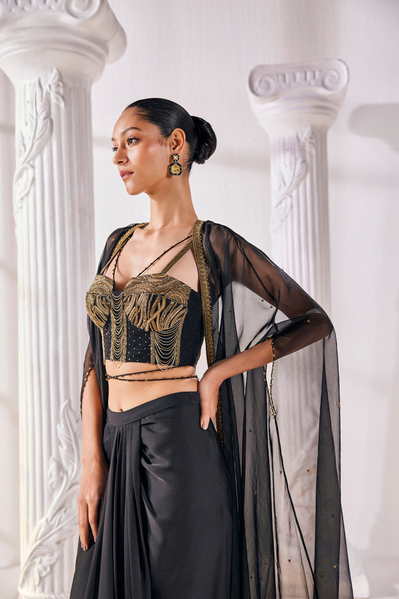 Draped Skirt Paired With An Embroidered Corset Blouse, Cape And A Belt.