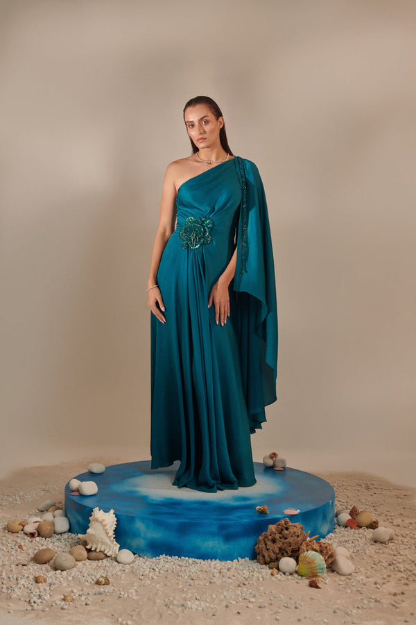 Teal One Shoulder Drape Gown ; Hand Embroidered 3D Shells At Waist, 3 Hand Embroidered Chains At The Sleeve; Asymmetric Open Drape  Sleeve