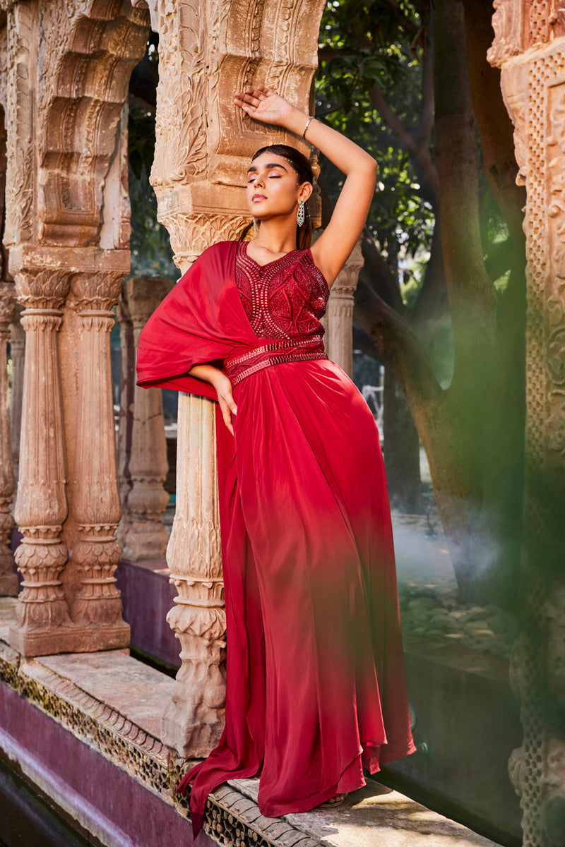 Red Gown With Sari Drape And An Embroidered Belt.